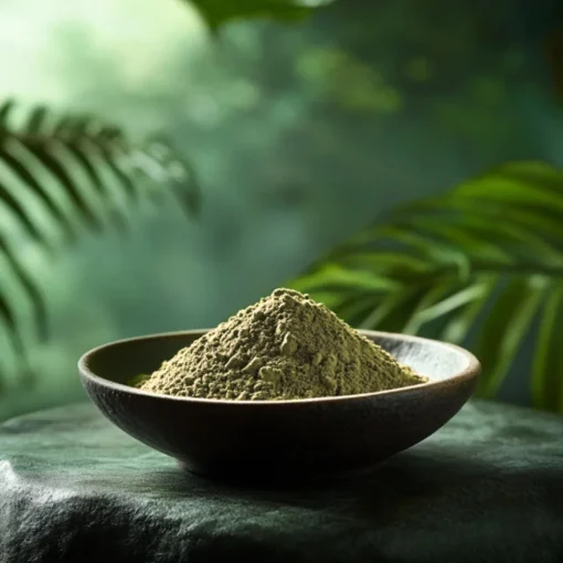 A bowl of green Mitragyna Hirsuta on a flat rock.