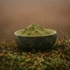 A bowl of Green maeng da kratom on the forest.