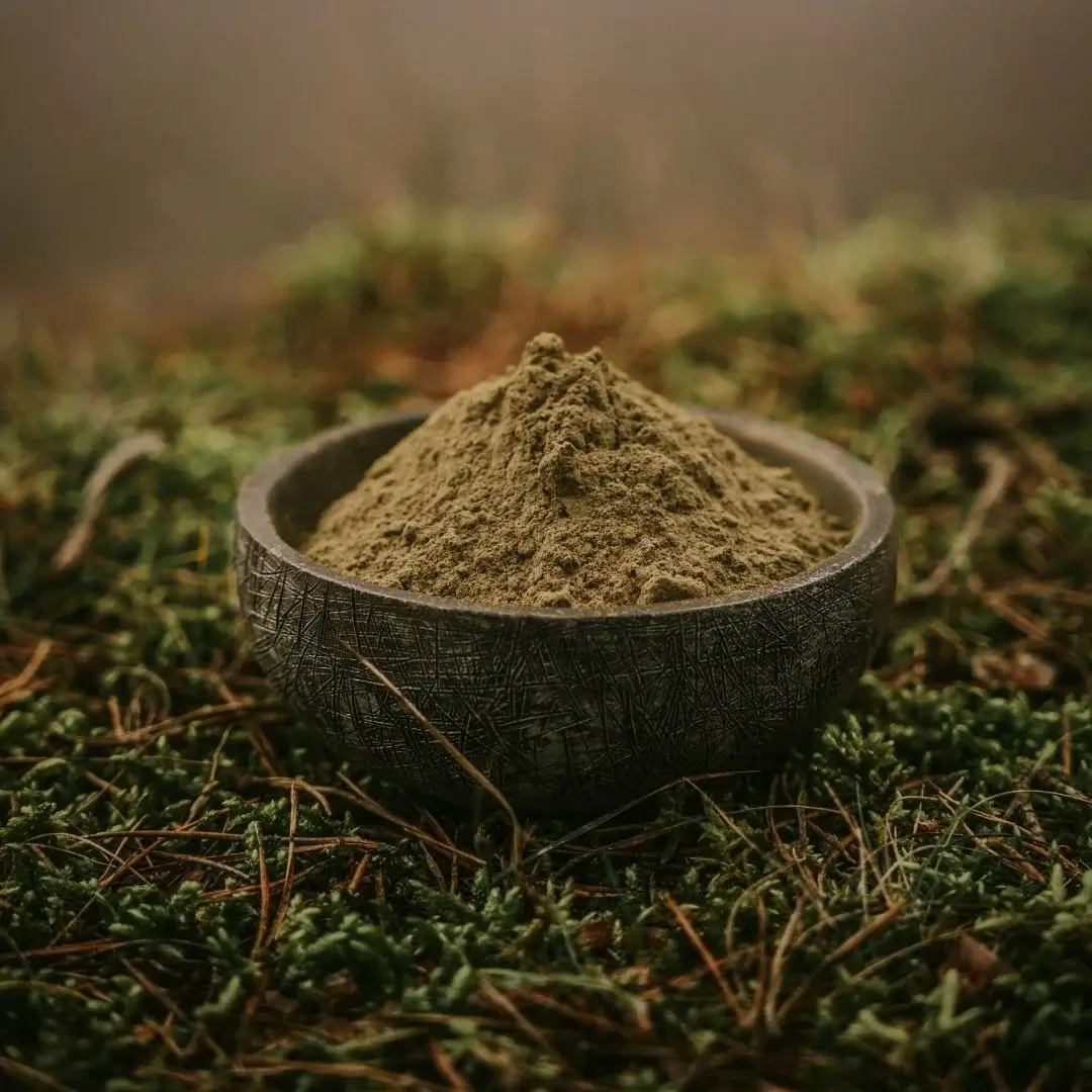 Red Maeng Da kratom in a bowl in nature.