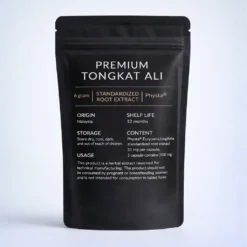 A Tongkat Ali Physta matte black stand-up pouch labeled “Premium Tongkat Ali” is shown against a soft light gray background. The packaging features white and gold text with product details including origin, shelf life, storage, content, and usage instructions.